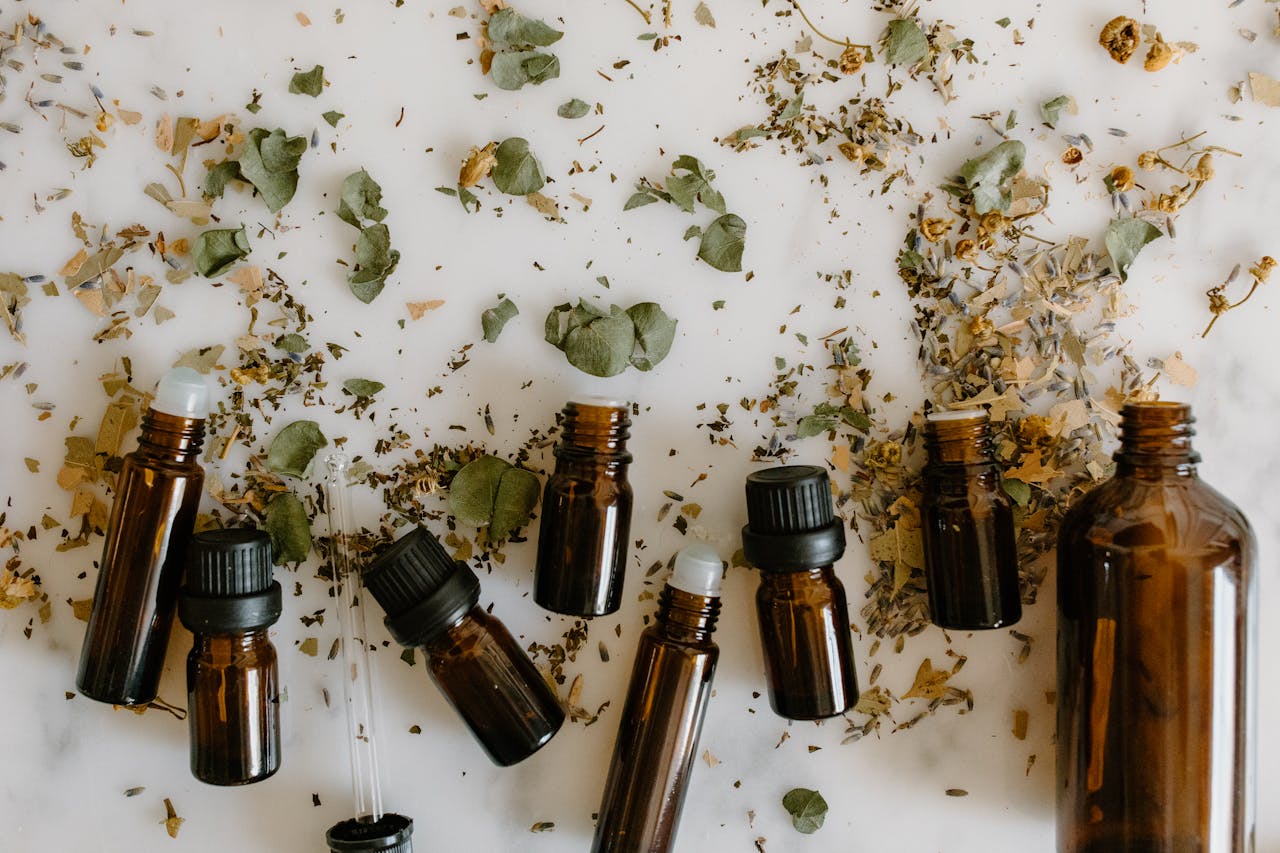 hero-gallery-01 Flat lay of brown glass bottles and dried herbs, perfect for aromatherapy themes.